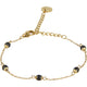 Gouden armband met zwarte keramieken kralen