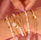 Golden Beaded Bracelet with Heart and Precious Stone - White Quartz