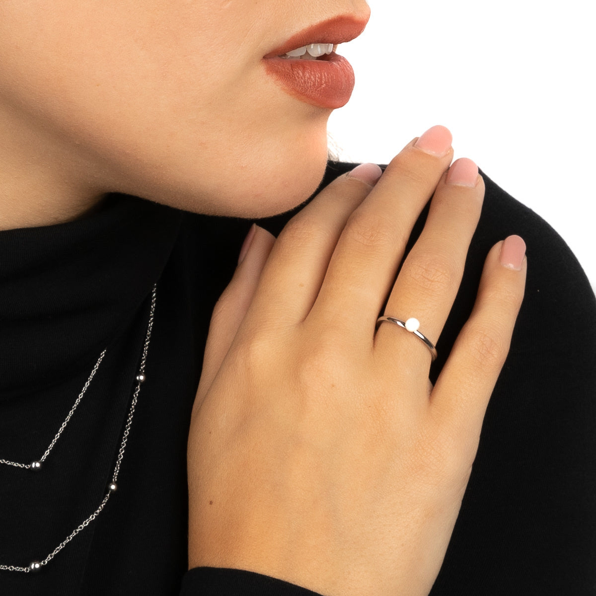 Silver stacking ring with ceramic bead.
